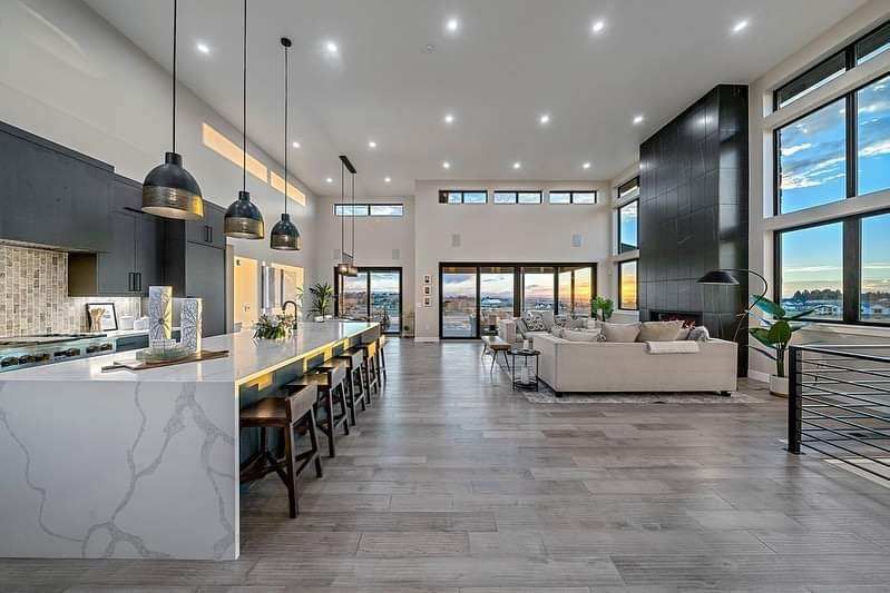 Bright modern open-plan kitchen and living room with large windows and city view