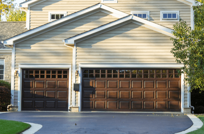 A house with two garage doors and a driveway | Siefken Roofing and Remodeling Services in Omaha, NE