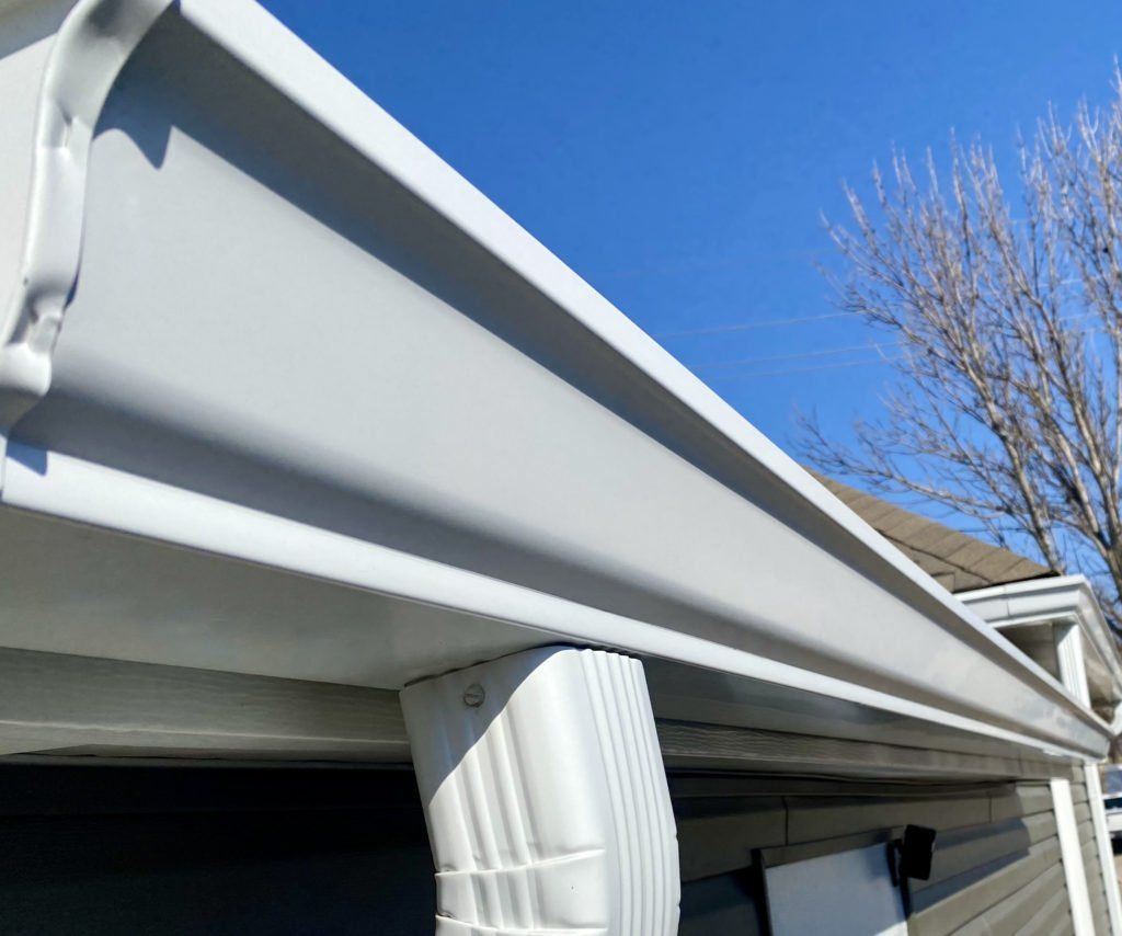 A white gutter on the side of a house | Siefken Roofing and Remodeling Services in Omaha, NE