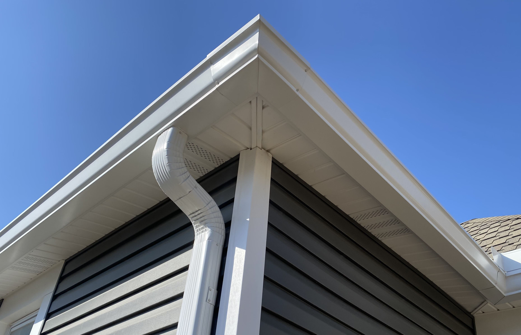 A house with a white gutter on the side of it | Siefken Roofing and Remodeling Services in Omaha, NE
