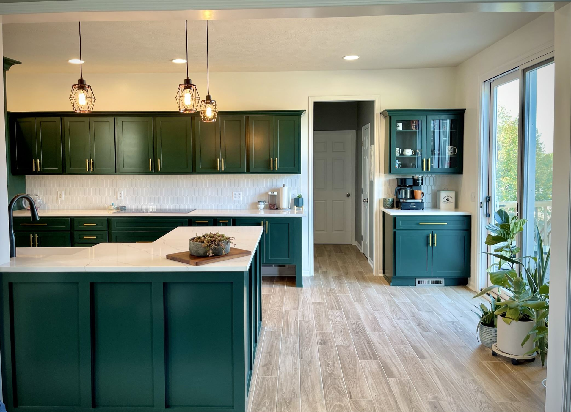 A kitchen with green cabinets and a large island | Siefken Roofing and Remodeling Services in Omaha, NE