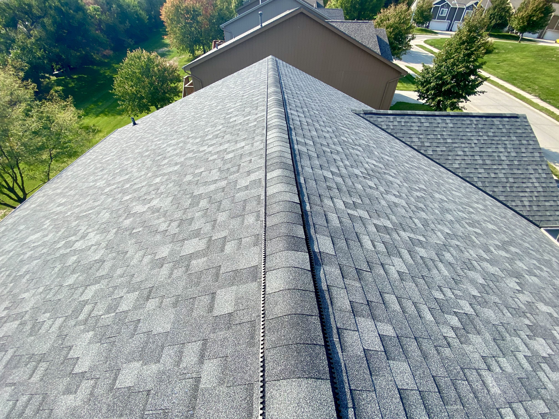An aerial view of a roof of a house in a residential area | Roofing Projects | Siefken Roofing and Remodeling Services in Omaha, NE