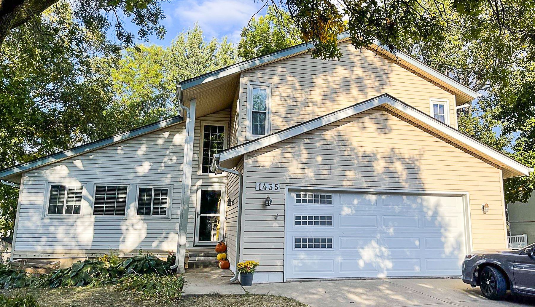 A house with a car parked in front of it | Siding Projects | Siefken Roofing and Remodeling Services in Omaha, NE