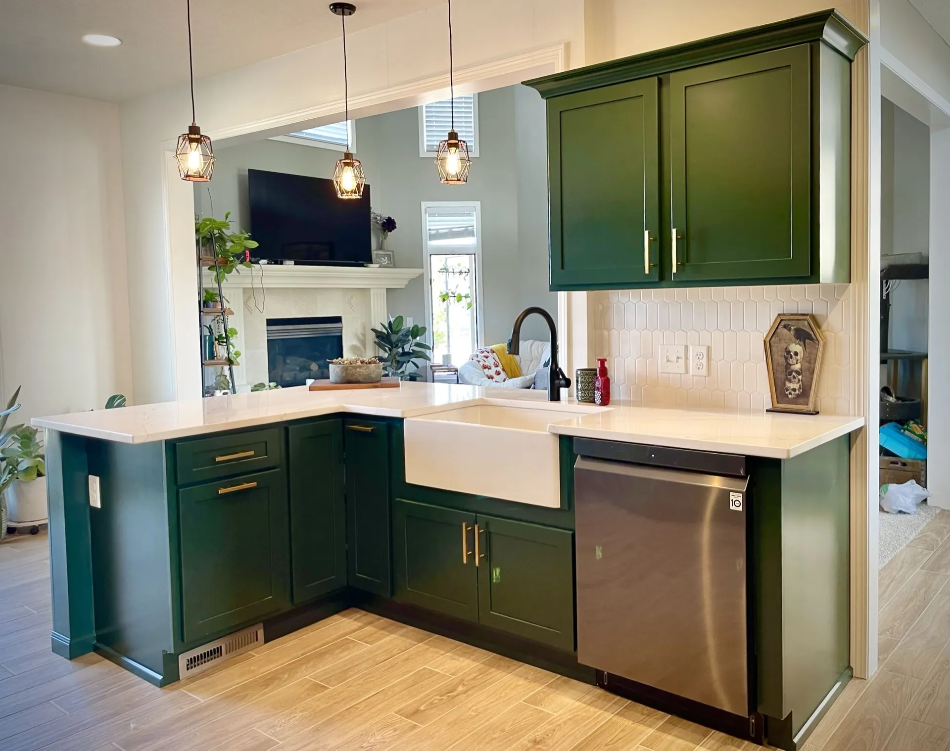 A kitchen with green cabinets and stainless steel appliances | Kitchen Projects | Siefken Roofing and Remodeling Services in Omaha, NE
