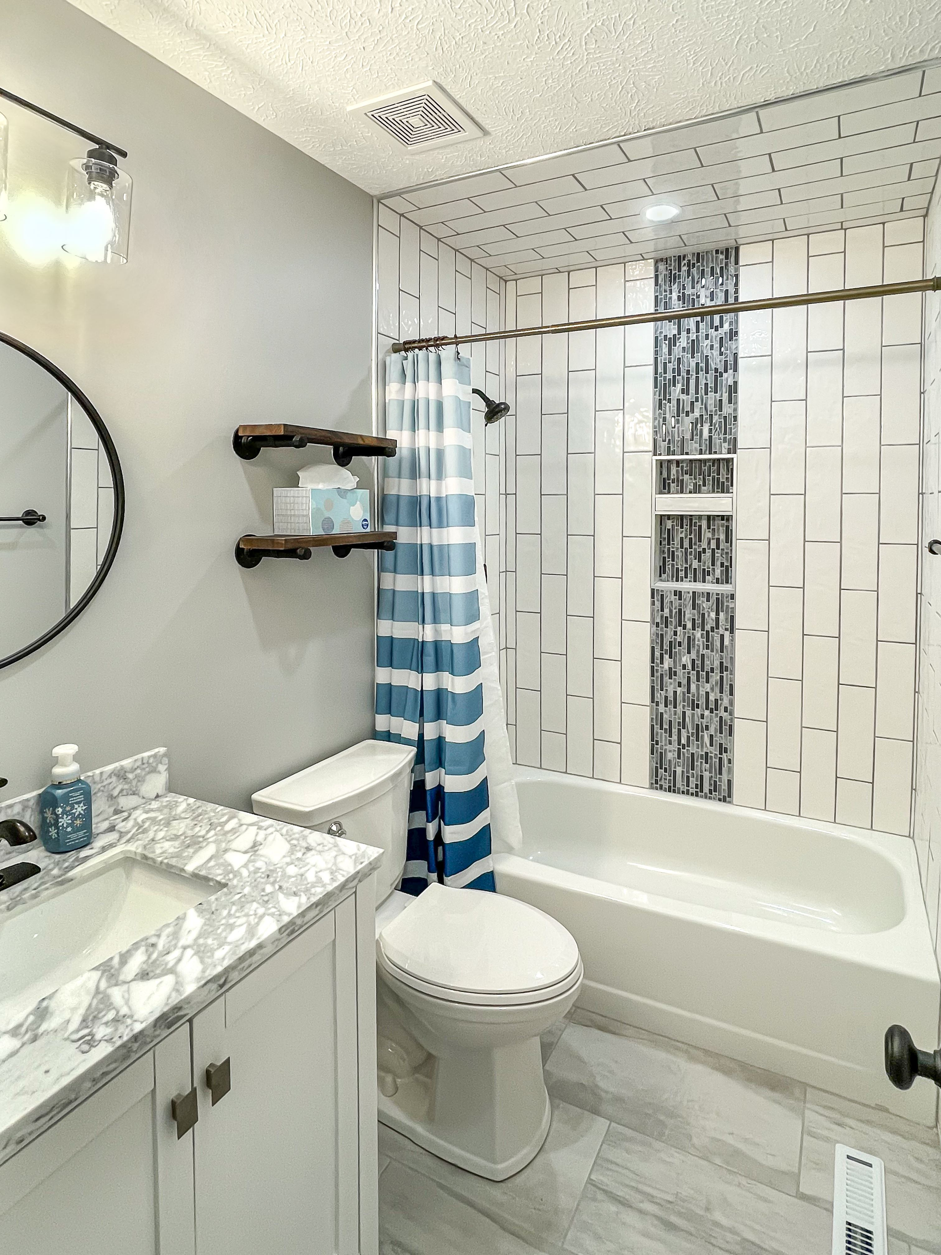 A bathroom with a toilet a sink and a bathtub | Bathrooms Projects | Siefken Roofing and Remodeling Services in Omaha, NE