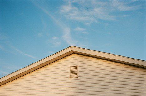 The roof of a house with a blue sky in the background | Siefken Roofing and Remodeling Services in Omaha, NE