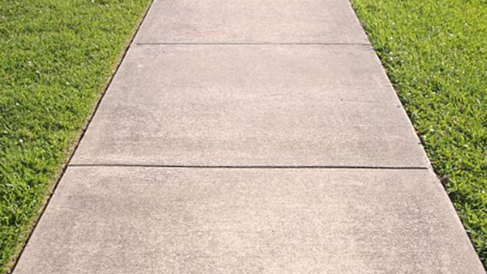 A concrete sidewalk leading to a grassy field | Kitchen Projects | Siefken Roofing and Remodeling Services in Omaha, NE