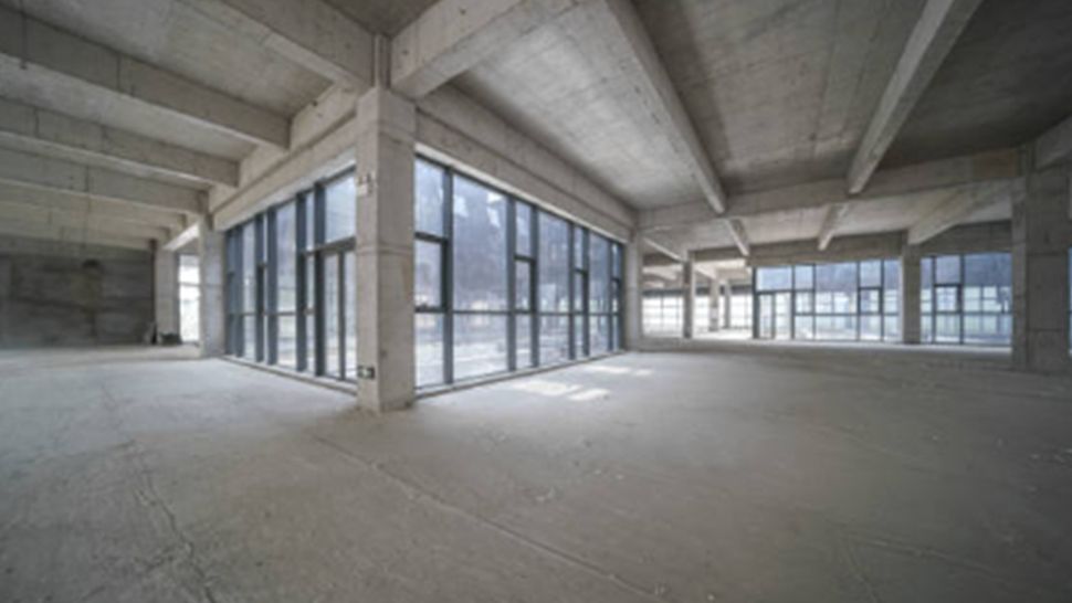An empty building with a lot of windows and concrete columns | Kitchen Projects | Siefken Roofing and Remodeling Services in Omaha, NE