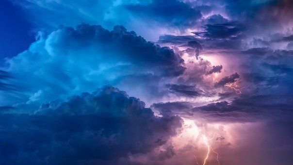 A lightning bolt is shining through the clouds in a stormy sky | Kitchen Projects | Siefken Roofing and Remodeling Services in Omaha, NE