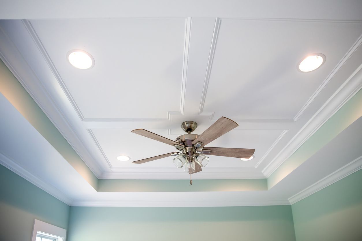 Ceiling with recessed lighting, crown molding, and ceiling fan, in a room with light green walls.
