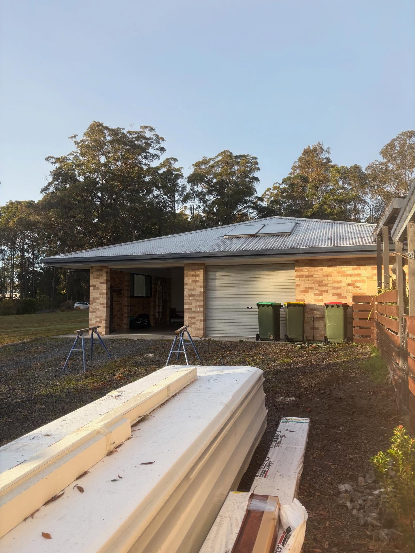 Construction Site Showing a Brick Garage Exterior With a Metal Roof — Coastbuilt Building Services in Thrumster, NSW
