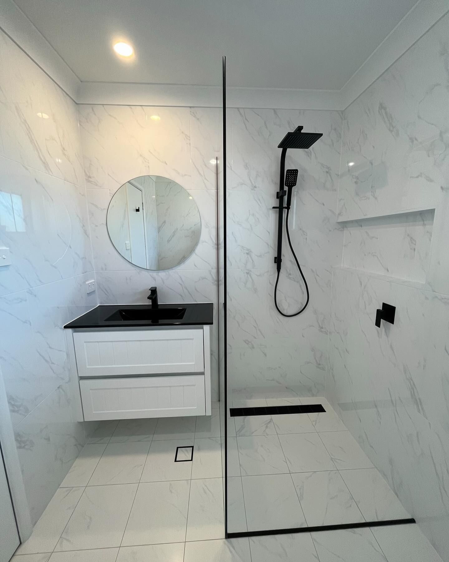 A Bathroom Featuring White Marble-look Walls and Floors — Coastbuilt Building Services in Thrumster, NSW