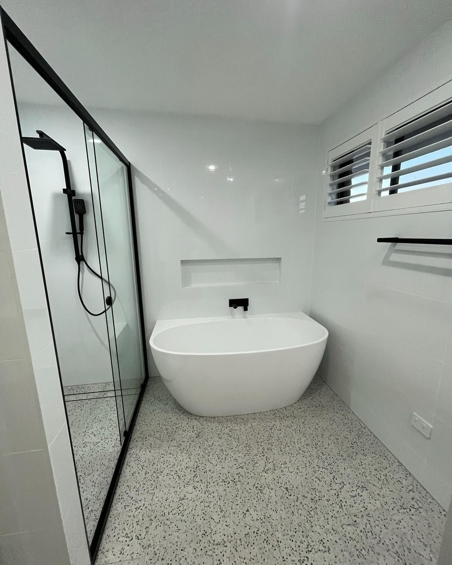 Modern Bathroom With a Freestanding White Bathtub — Coastbuilt Building Services in Thrumster, NSW