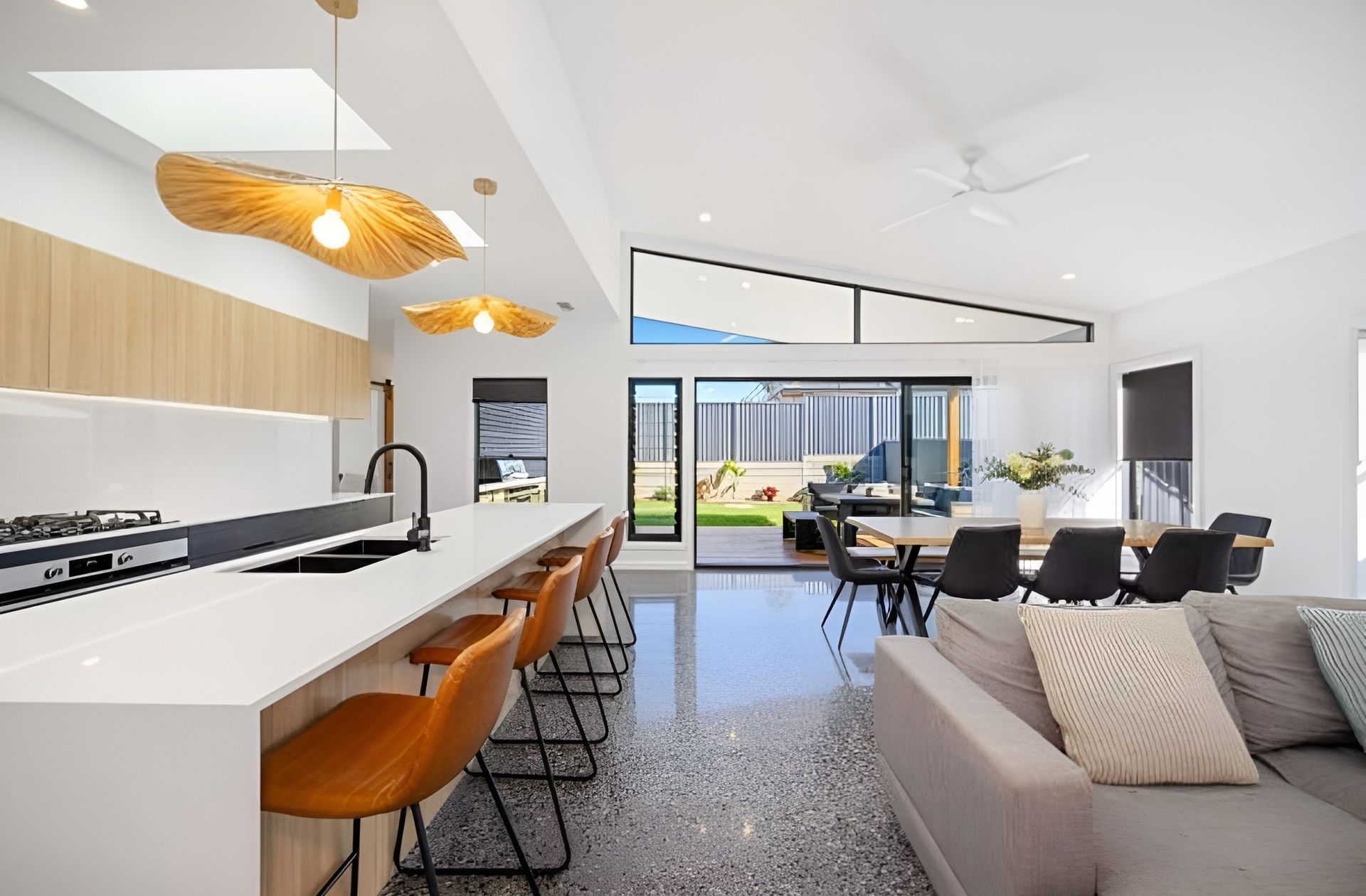 Modern Open-plan Kitchen and Living Area With Island Seating — Coastbuilt Building Services in Thrumster, NSW