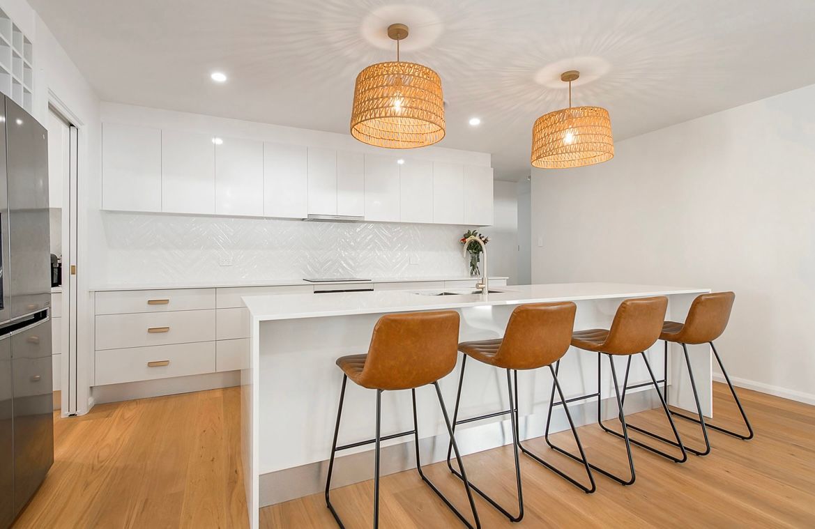 A Modern Kitchen Featuring White Cabinets — Coastbuilt Building Services in Thrumster, NSW