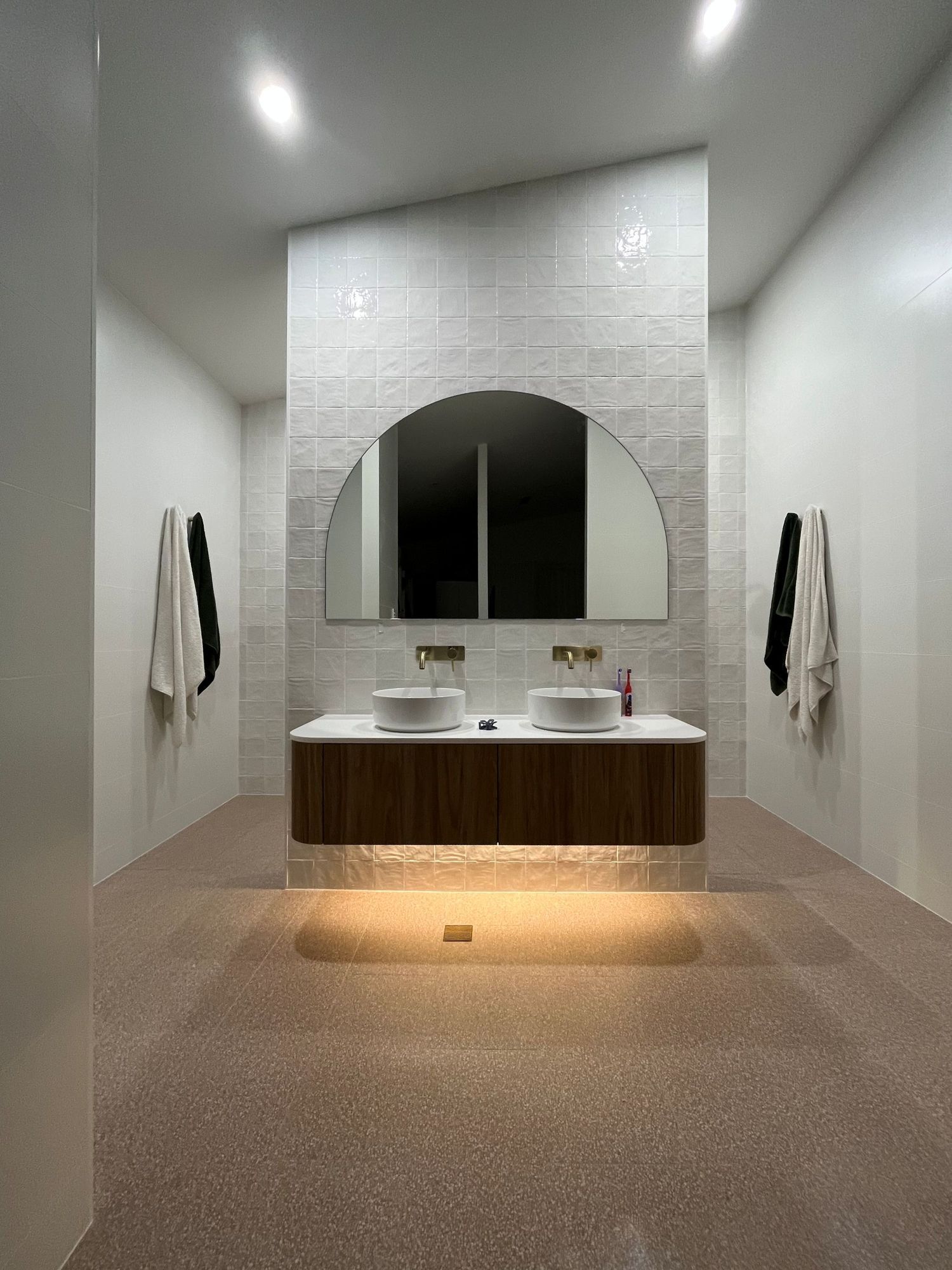 A Modern Bathroom Featuring a Floating Wooden Vanity — Coastbuilt Building Services in Thrumster, NSW