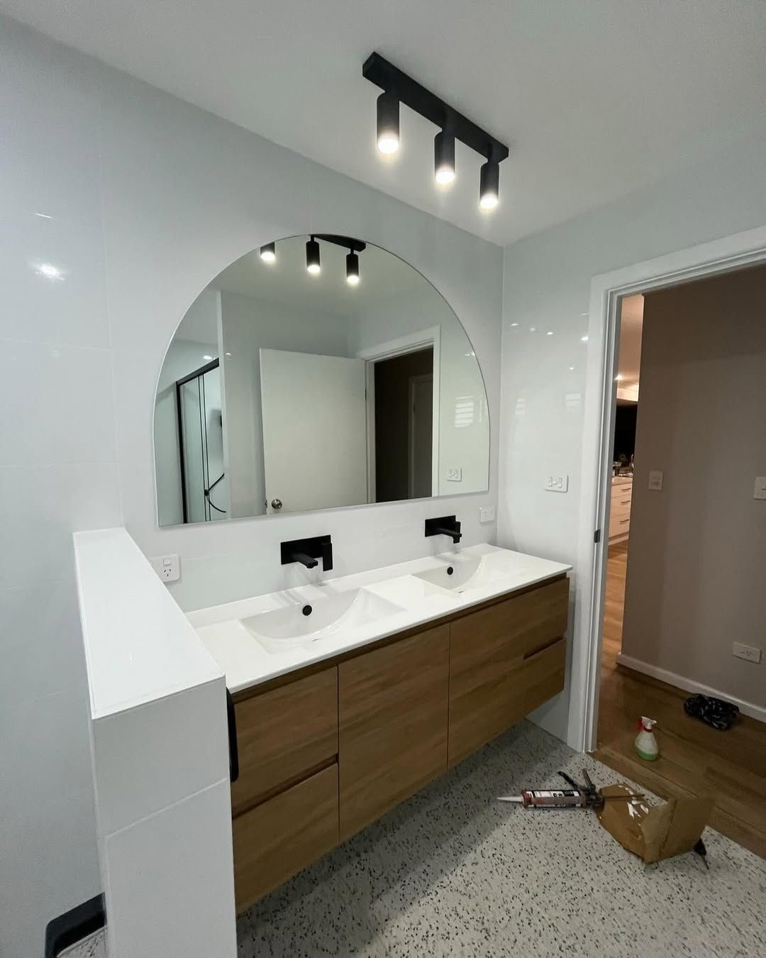 A Modern Bathroom Vanity With a Wood Cabinet, White Countertop — Coastbuilt Building Services in Thrumster, NSW