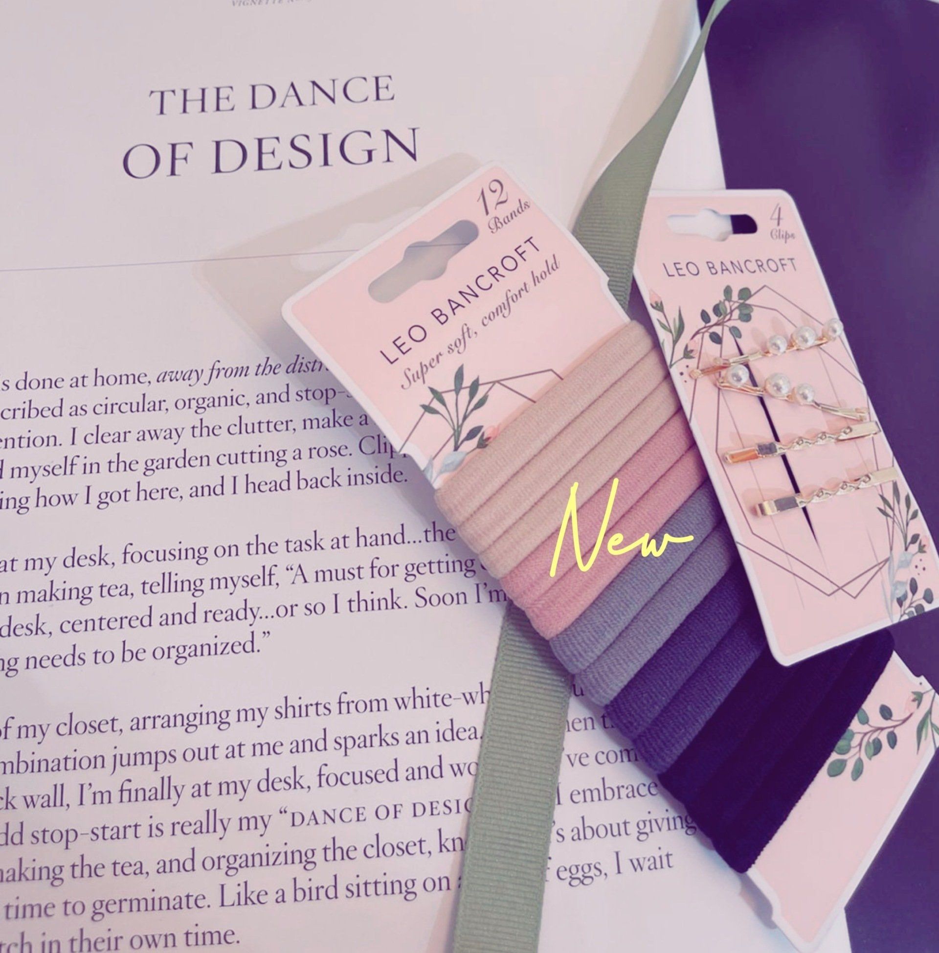 “Leo Bancroft” nail strip cards with purple ombré nails on a pastel magazine page