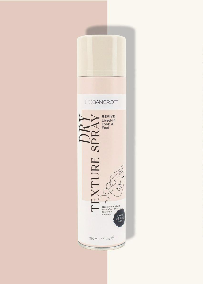 Leo Bancroft dry shampoo bottle with black text on a soft blush background