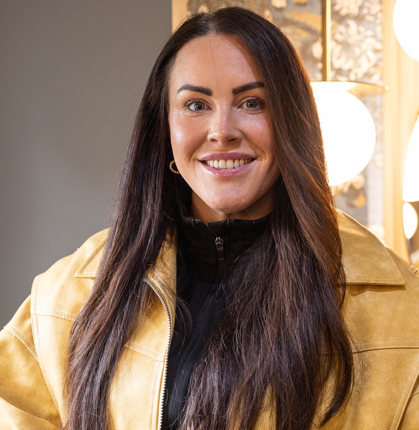 A woman with long dark hair is smiling in a circle