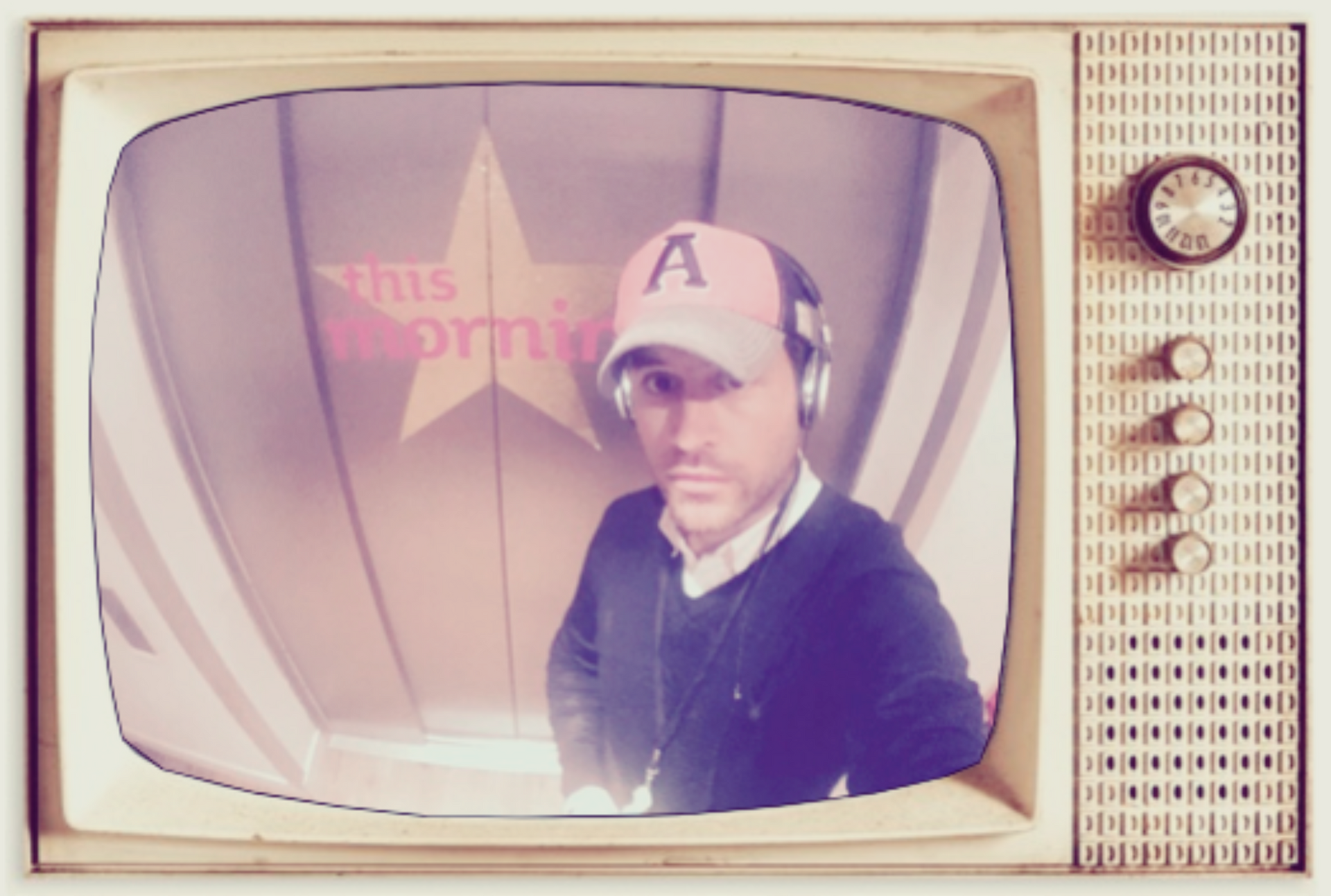 Vintage TV screen showing a man in a baseball cap with a star backdrop and retro controls