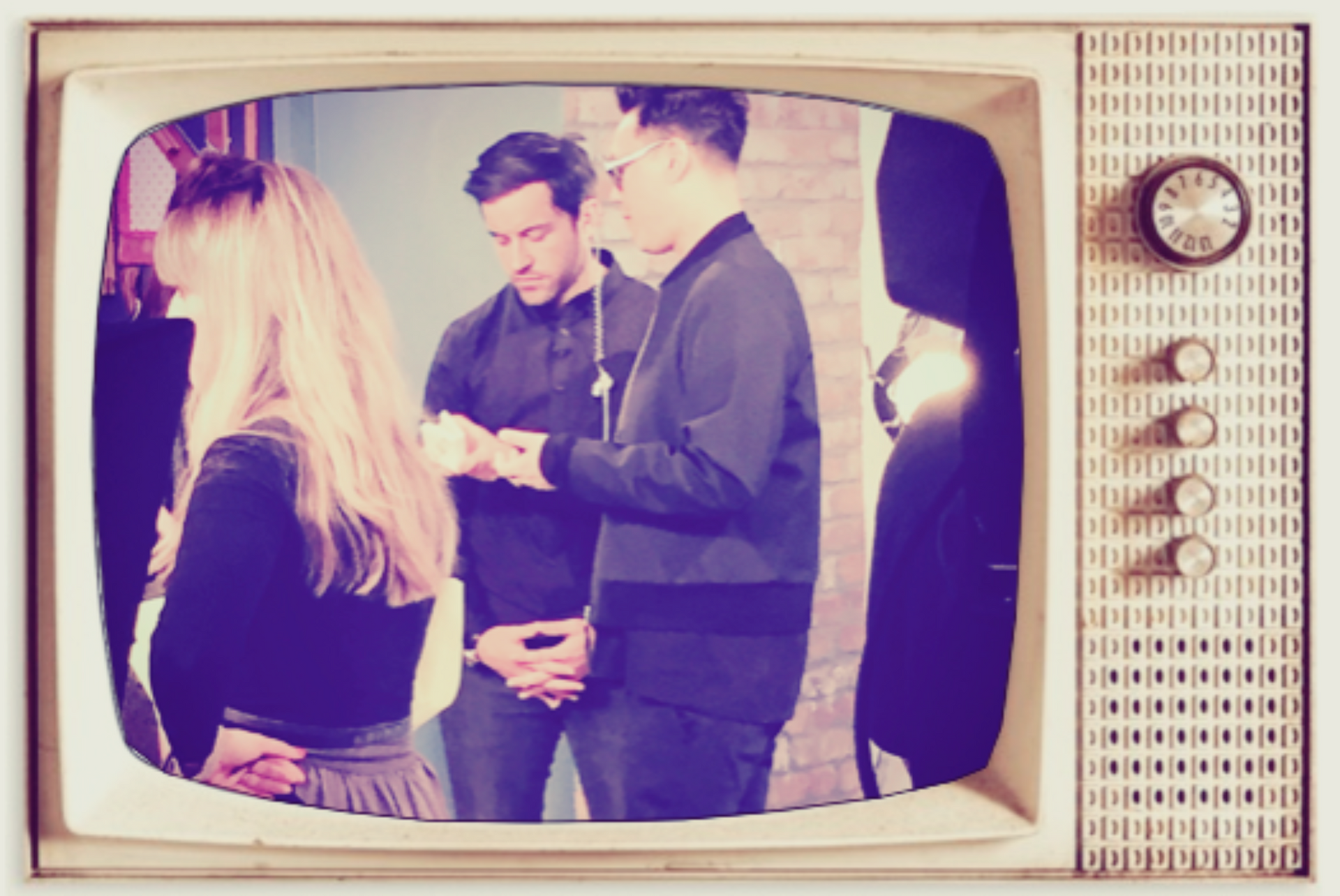 People gathered indoors, shown on a vintage TV screen.
