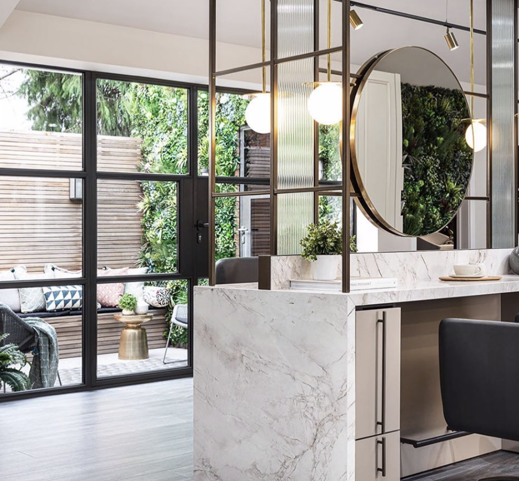 A hair salon with a chair and a mirror