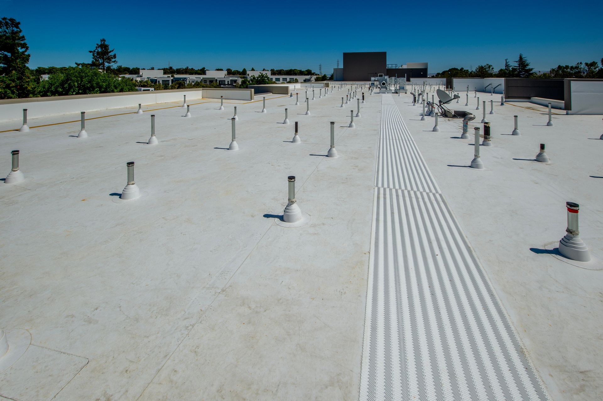 A large white roof with a lot of pipes on it.
