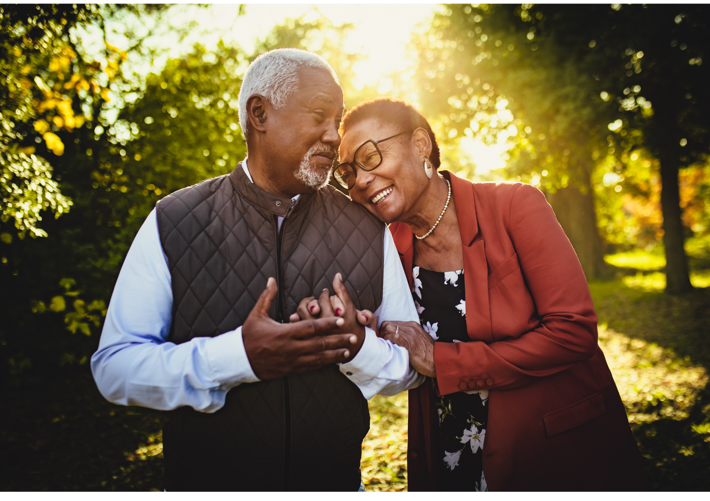 Older couple laughing while on a walk.