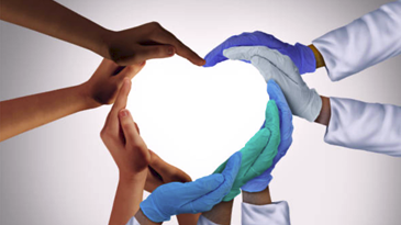 A group of doctors are making a heart shape with their hands