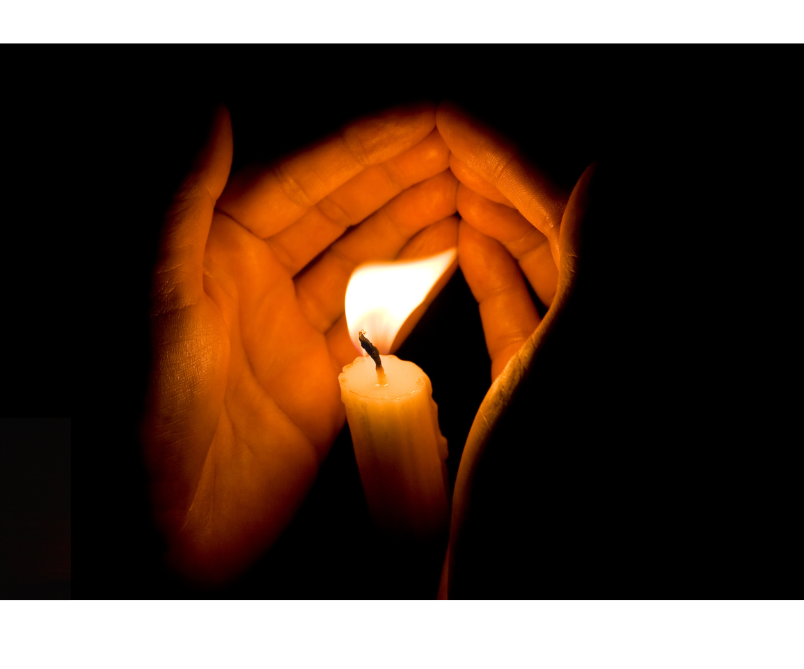 Hands cupped around a candle.