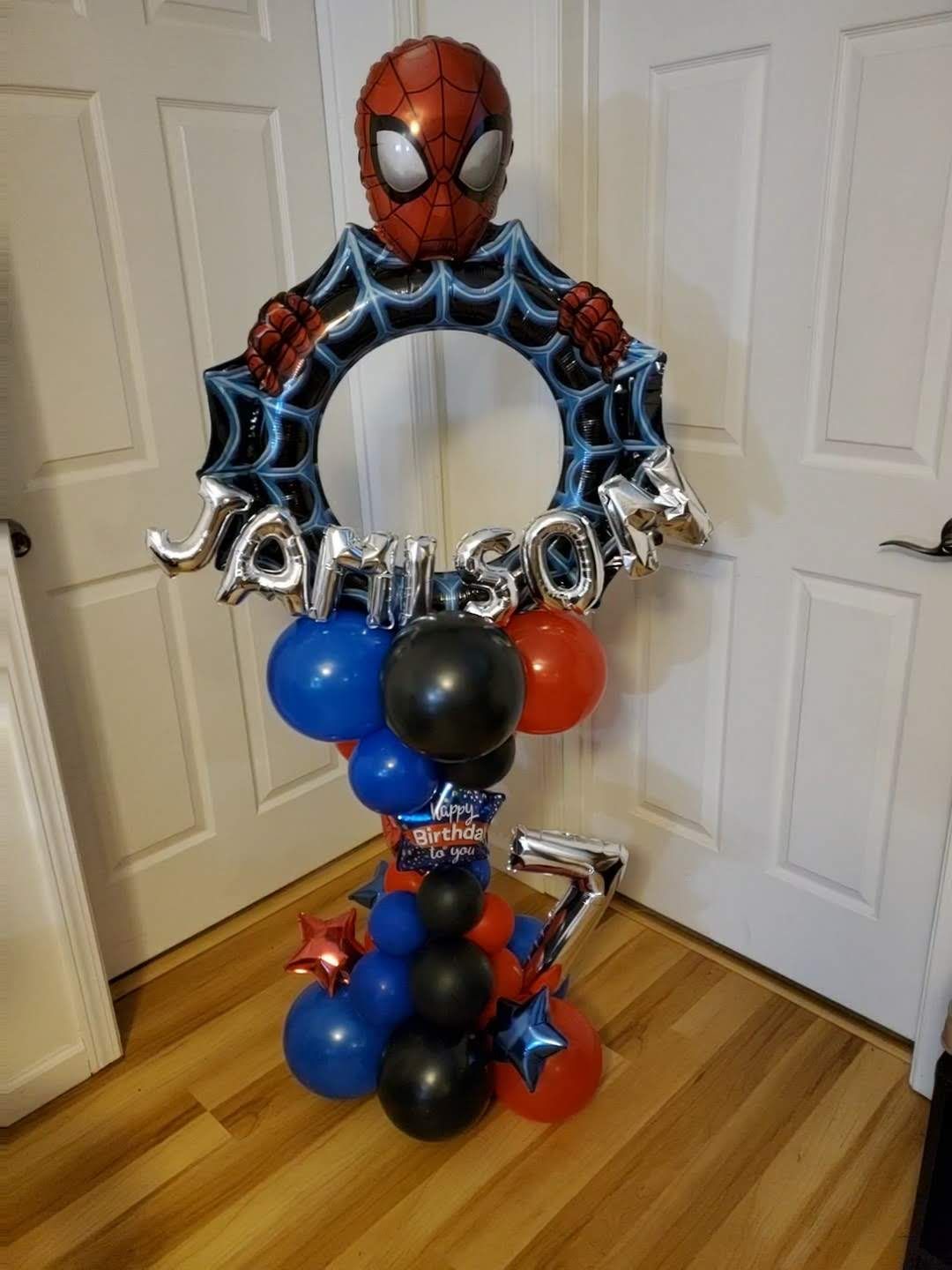 A Spider-Man themed balloon centerpiece with a 