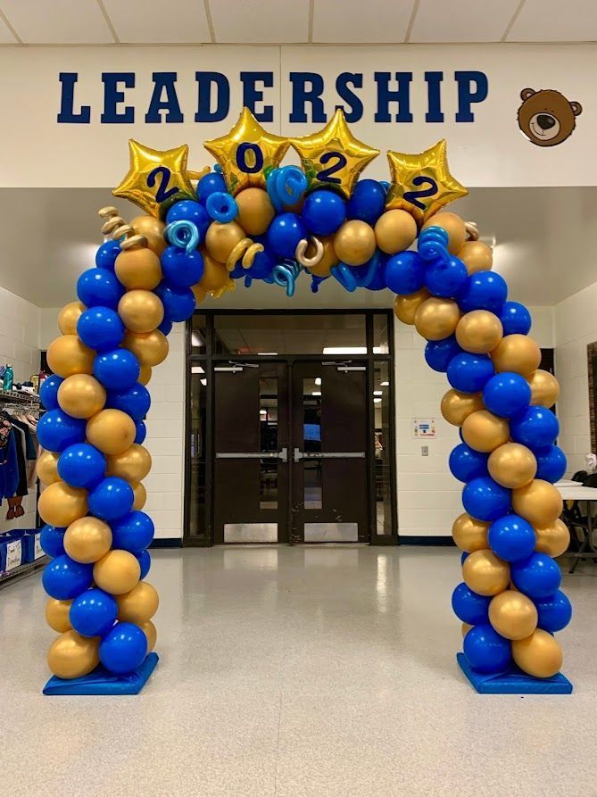 Blue and gold balloon arch with