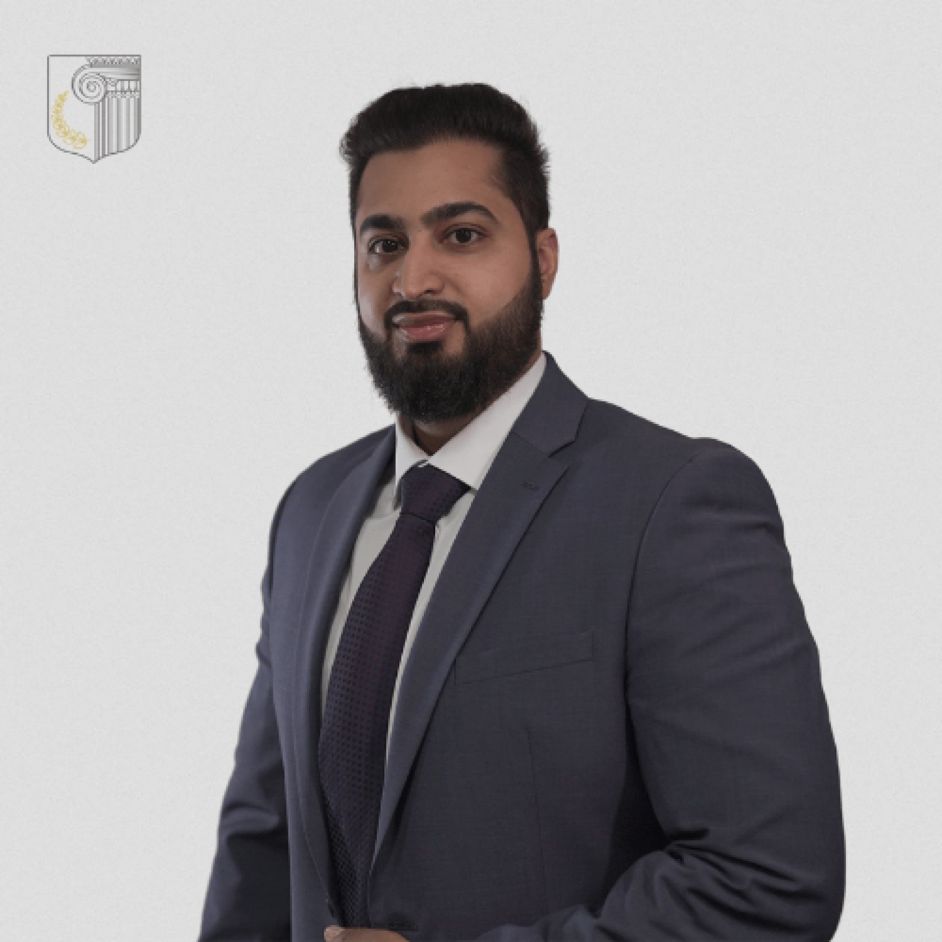 A man with a beard is wearing a suit and tie