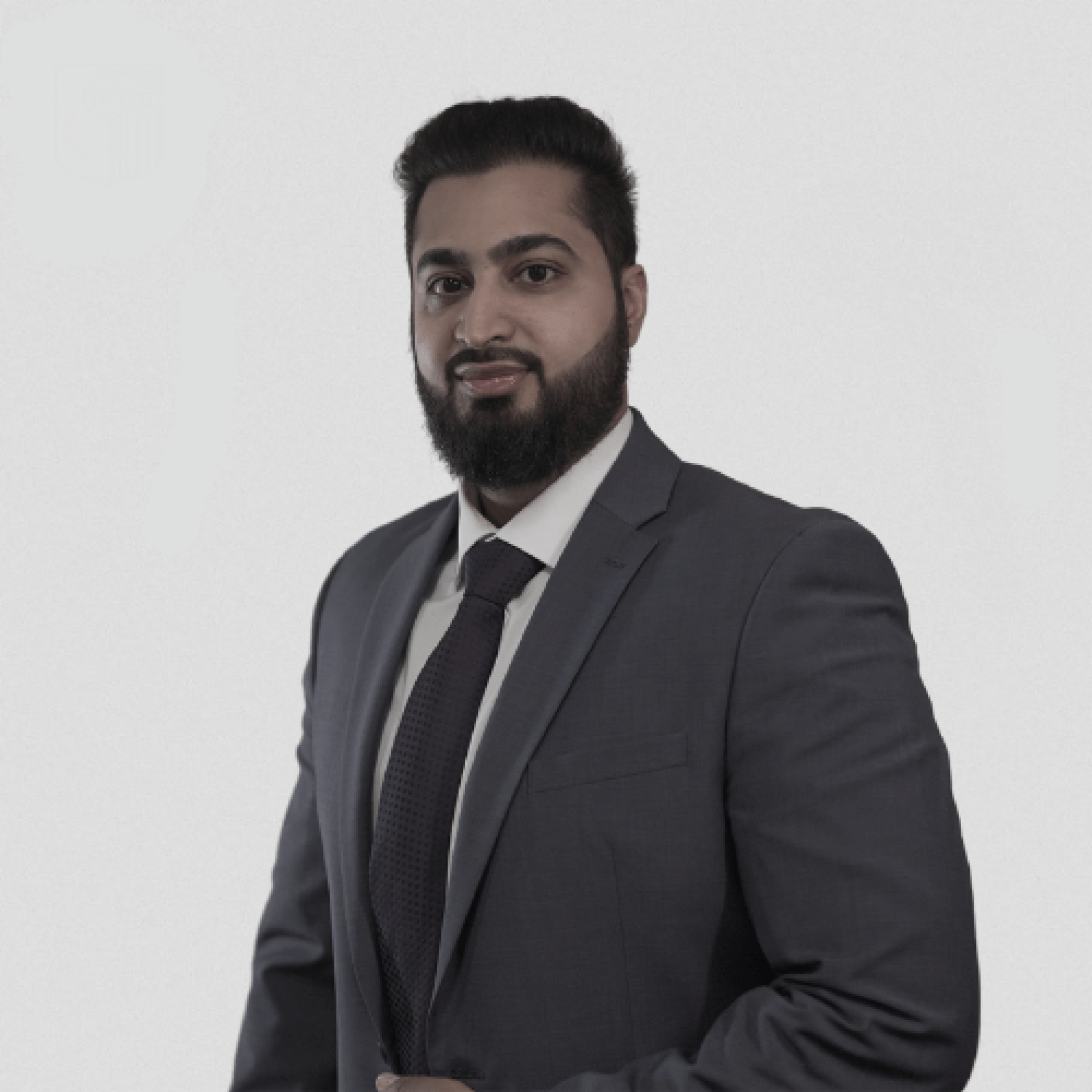A man with a beard is wearing a suit and tie