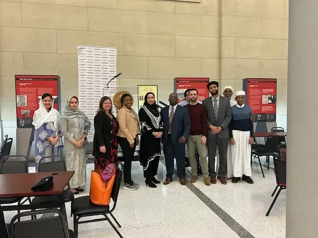 A group of people are posing for a picture in a room.