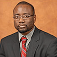 A man in a suit and tie is wearing glasses.