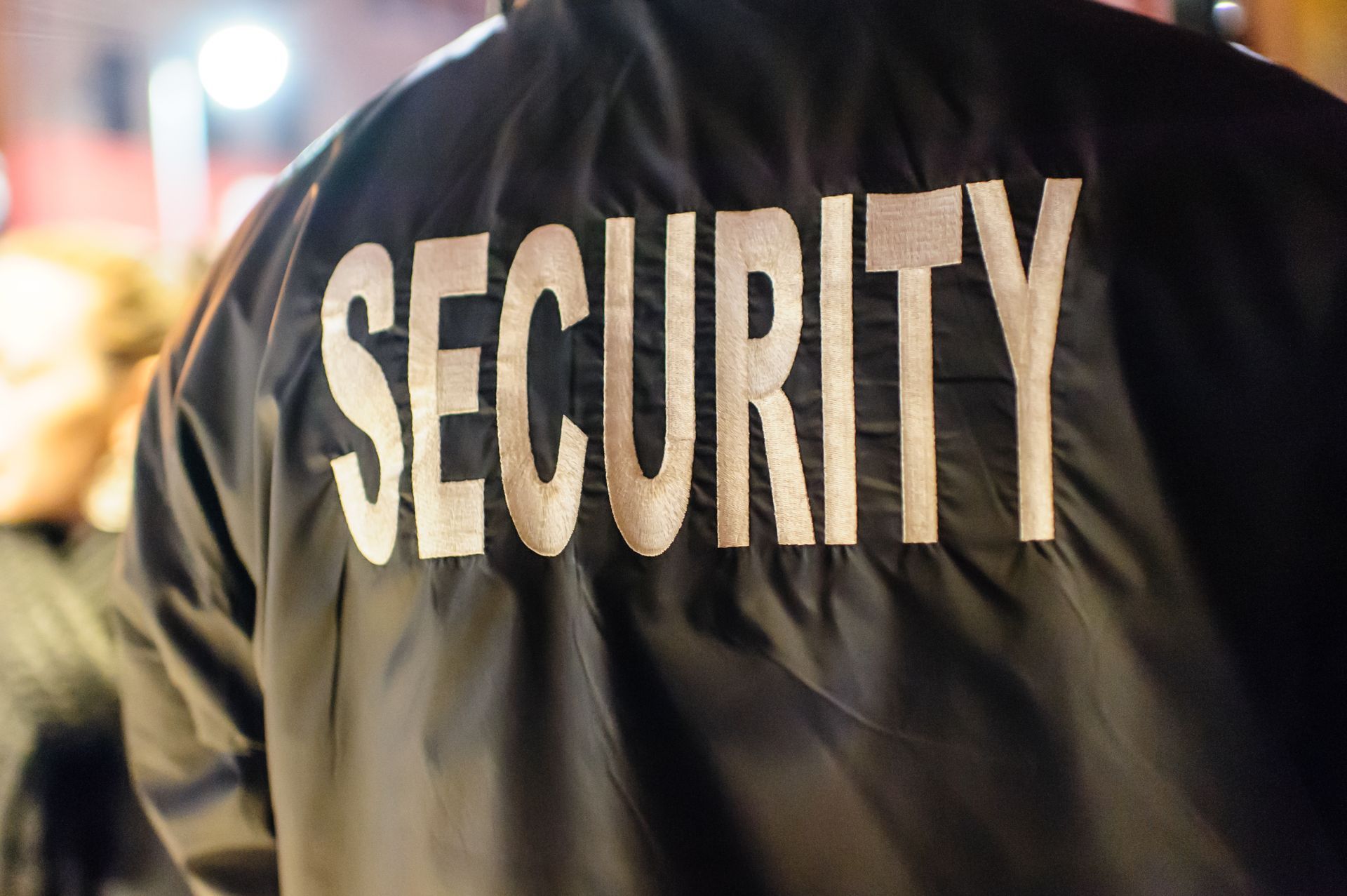 Close-up of a professional jacket for a reliable private security guard service at an event. Close-up of a professional jacket for a reliable private security guard service at an event.