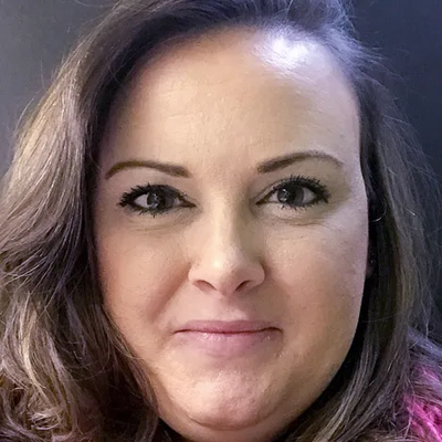 A close up of a woman 's face with a smile on her face.