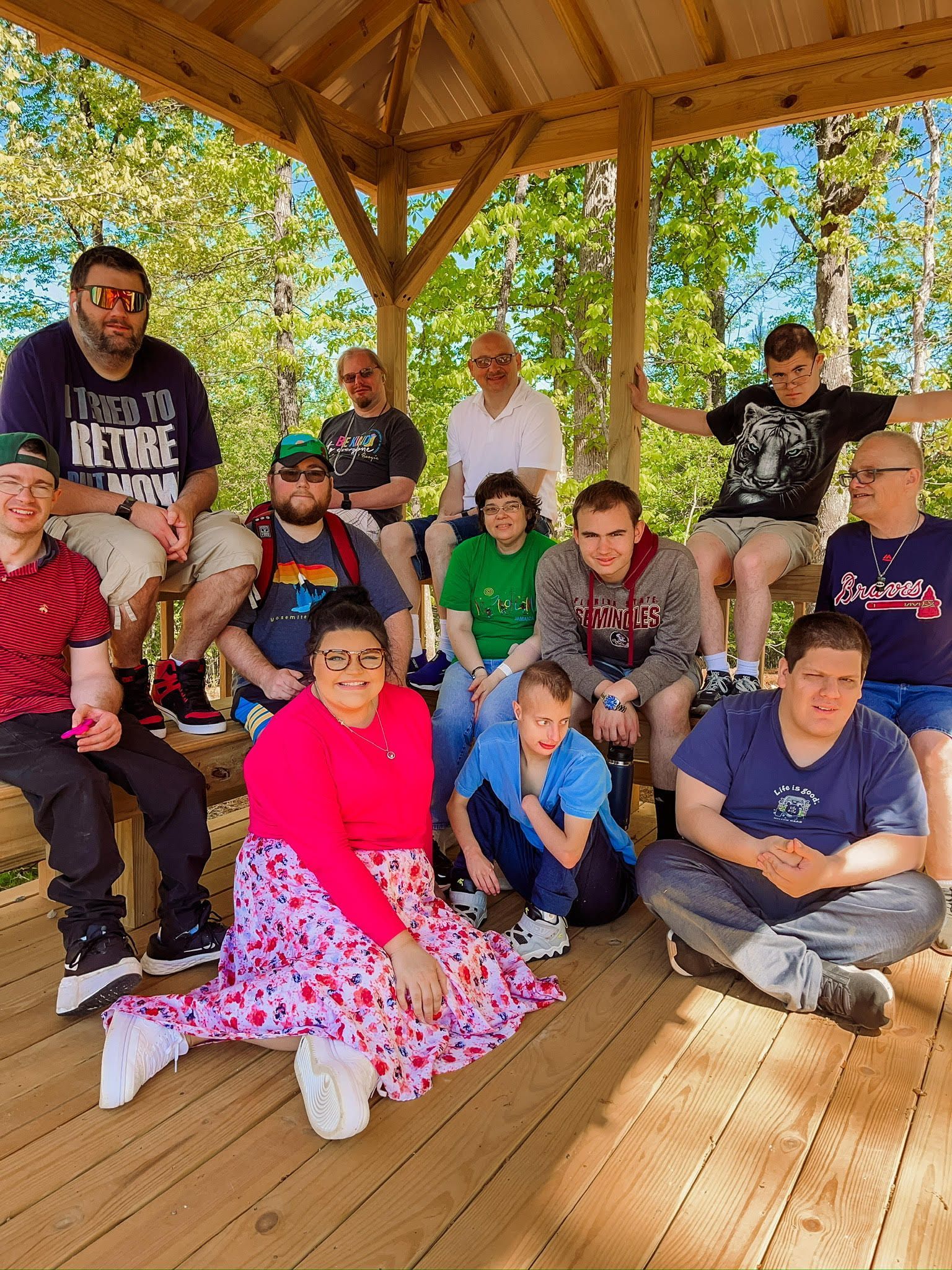 A group of people are posing for a picture under a gazebo.