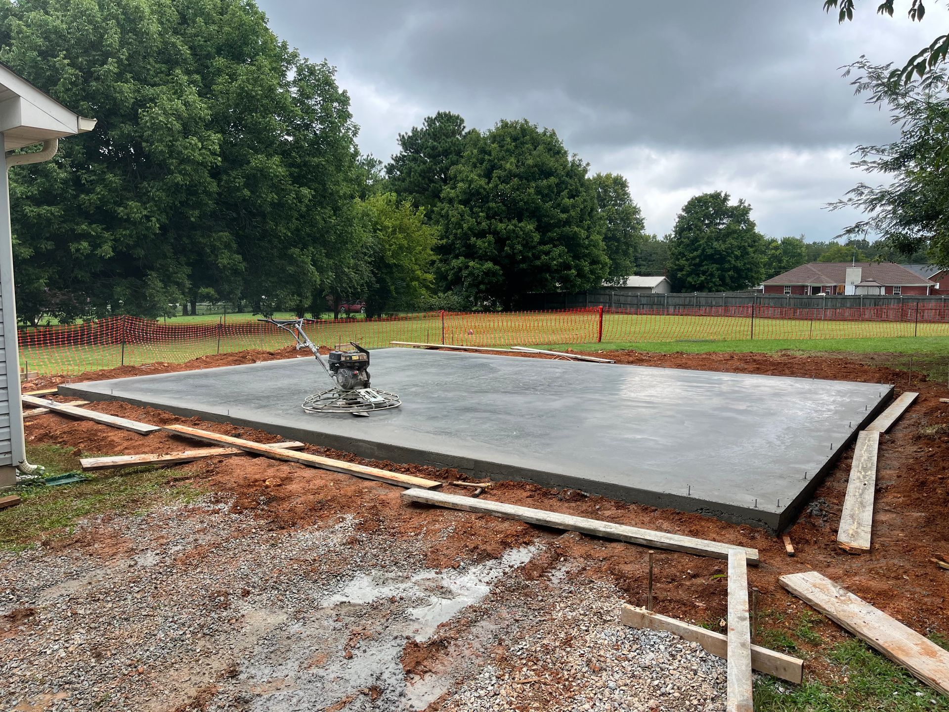 A large concrete slab is being built in a yard.