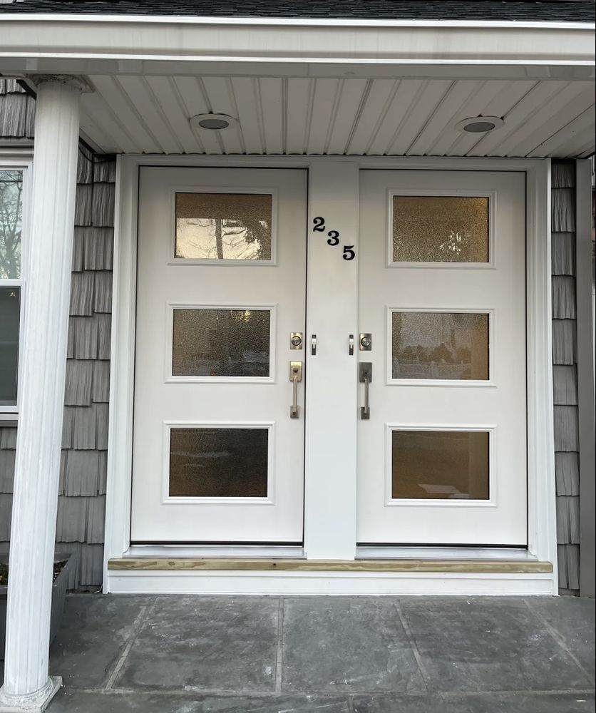 White double doors with glass panels and the number 235 above the handles.