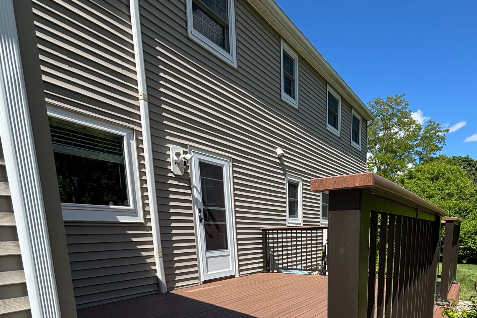 A large house with a large deck in front of it.