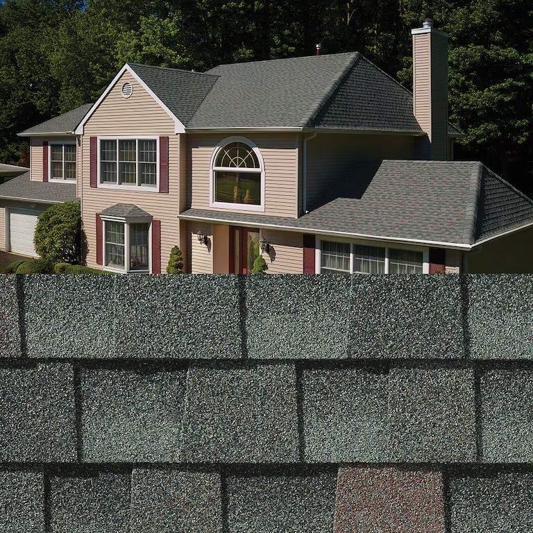 Suburban house with green roof behind a tall stone wall, surrounded by trees
