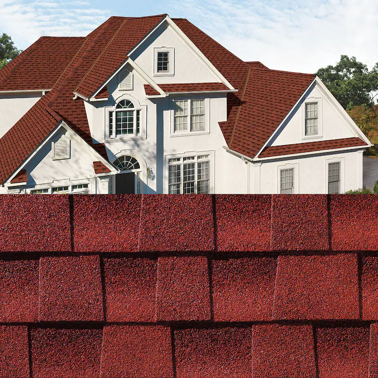 Red shingle house behind a close-up of matching red roof shingles