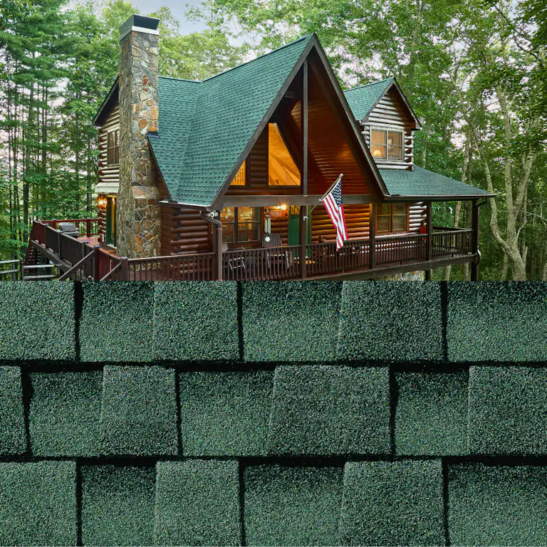 Rustic cabin with green roof and stone chimney in a wooded setting, with an American flag on the porch