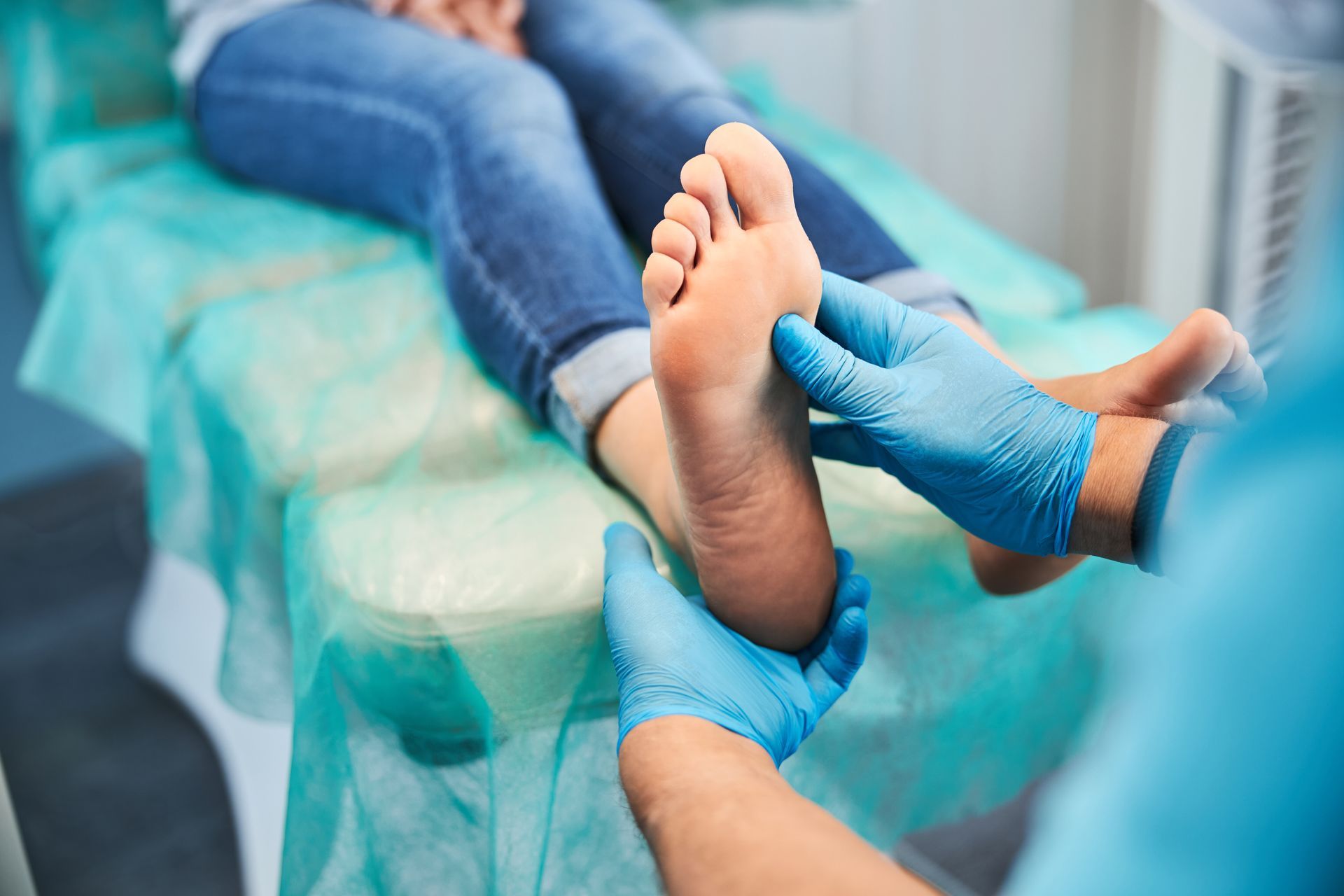 A podiatrist is checking a patient’s feet.