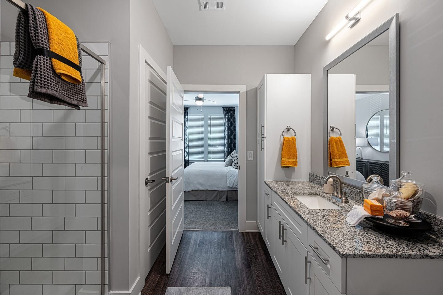 A bathroom with a sink a mirror and a walk in shower