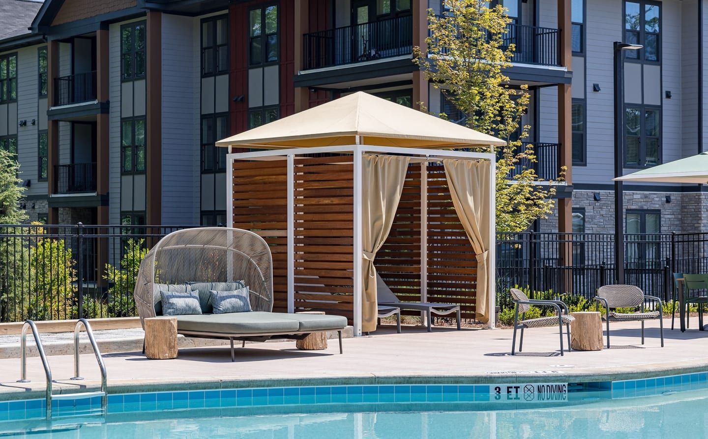 A swimming pool with a gazebo in the middle of it
