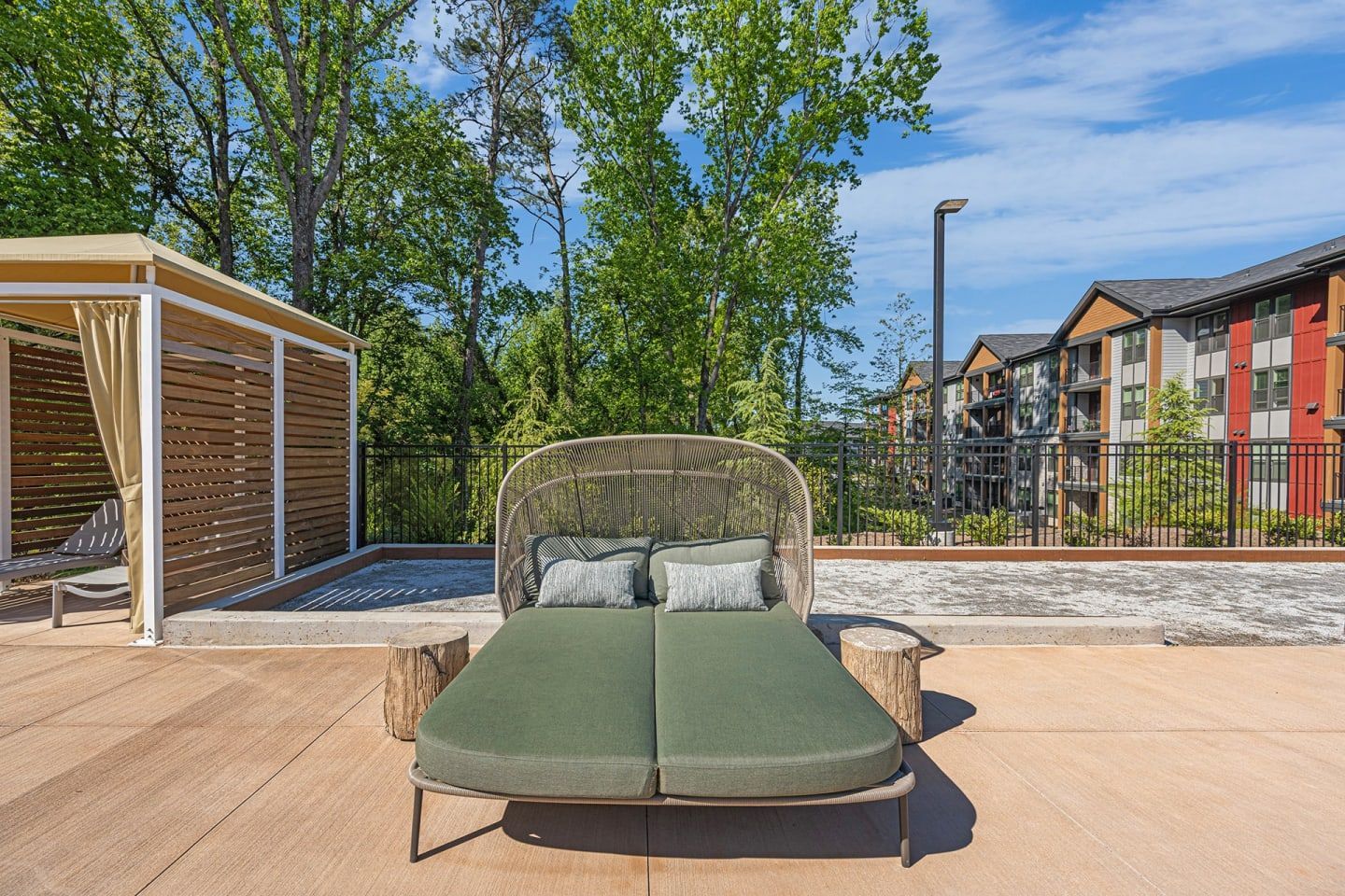 A large bed is sitting on a patio in front of a building